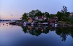 Cape with summer houses and fishing stalls in Vaxholm a beautiful summer evening